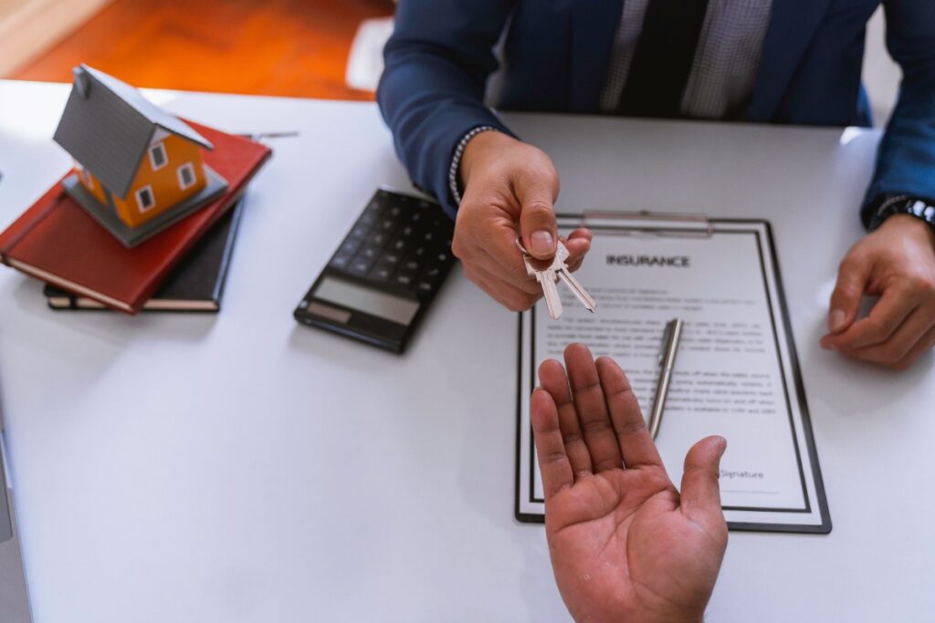 Un agent immobilier qui donne des clés à une personne