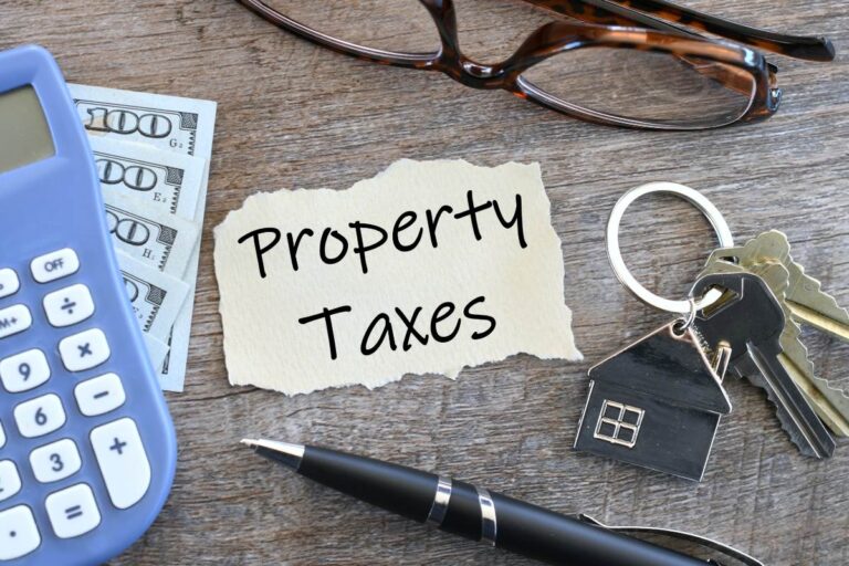 Une calculatrice, taxe, stylo et clé d'une maison