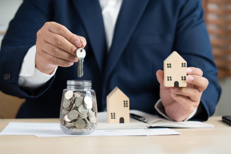 Main d'un homme qui tient une clé de maison