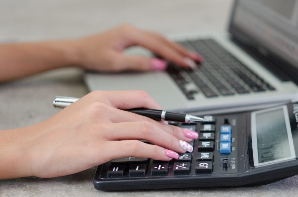 Une femme travaillant ordinateur avec une calculatrice